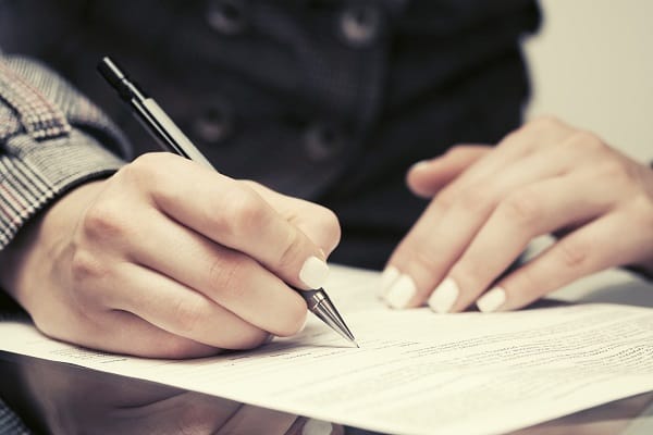 A business woman signing a bankruptcy petition