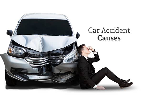 A man sits next to his wrecked car looking distressed beneath the words "Car Accident Causes"